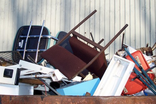 Man and van loading household items from a flat above shops