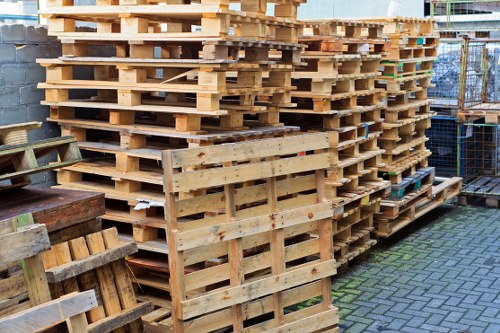 Lorry loading a skip on a residential street
